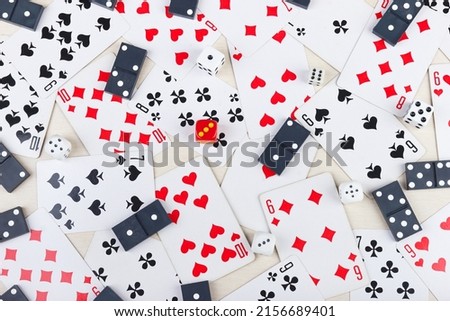 Dominoes, playing cards and dice for board games on a light table. View from above.