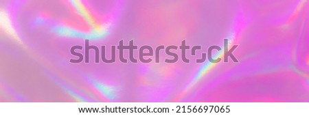 Blurred Holography abstract background in pink colors. Banner. Holographic color wrinkled pearlescent foil. Holographic prism light abstract background.