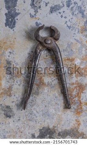 Old rusty construction tools on a gray iron background 