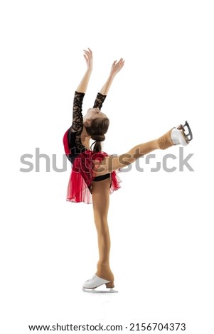 Beauty. Portrait of little flexible girl, figure skating wearing stage attire posing isolated on white studio backgound. Graceful and weightless. Concept of movement, sport, beauty. Copy space for ad