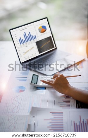 Businesswoman or accountant working Financial investment on calculator, calculate, analyze business and marketing growth on financial document data graph, Accounting, Economic, commercial concept. Royalty-Free Stock Photo #2156710939