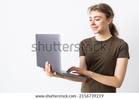 Young woman holding laptop on white background