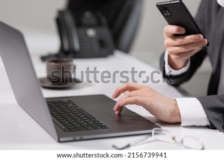 man taking pictures on laptop screen phone. screenshot