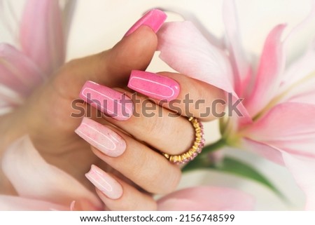 Pink elongated nail extension with fine glitter. Royalty-Free Stock Photo #2156748599