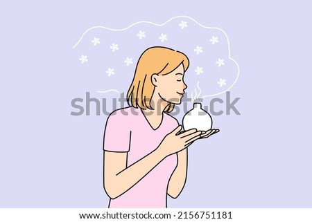 Happy young woman smell good pleasant fragrance from aromatherapy diffuser. Smiling girl enjoy essential oil in lamp. Flat vector illustration, cartoon character.  Royalty-Free Stock Photo #2156751181