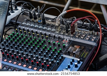 Sound audio mixer. General plan of sliders and buttons on a mixing console with connected audio jacks Royalty-Free Stock Photo #2156754853