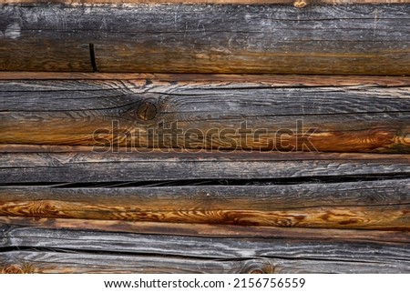 Horizontal wooden texture background from large logs. Brown boards with a natural pattern. High quality photo.