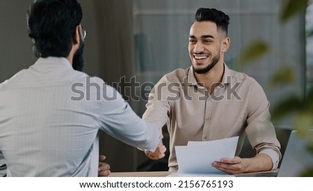 Two successful diverse business men colleague arabian salesman banker male manager shaking hand client customer accept common project successful corporate partnership deal agreement at office meeting Royalty-Free Stock Photo #2156765193
