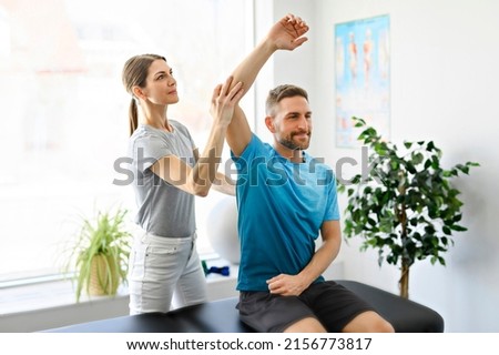 A Modern rehabilitation physiotherapy woman worker with man client Royalty-Free Stock Photo #2156773817