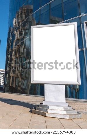 Advertising layout, empty banner on the city street against the background of a modern business center