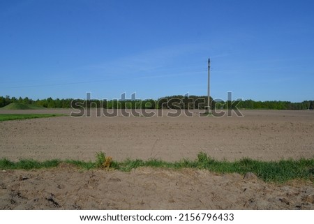 field plowed in spring blue sky above it