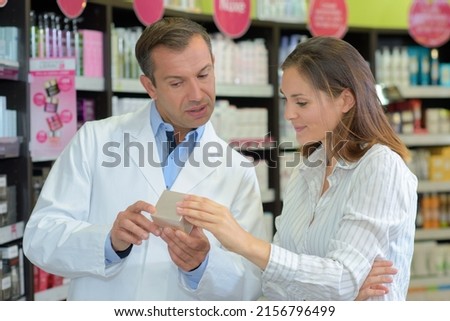 team of pharmacists advising customer