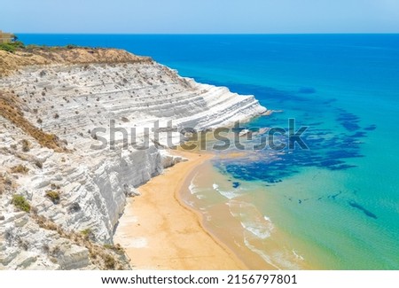 Scala dei Turchi (Italy) - The very famous white rocky cliff on the coast in the municipality of Porto Empedocle, province of Agrigento, Sicily, with beatiful golden beach and blue sea. Royalty-Free Stock Photo #2156797801