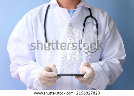 Doctor examines the bone hologram. Trauma, rheumatologist consultation, skeletal image, medical concept, future medical technologies Royalty-Free Stock Photo #2156827823