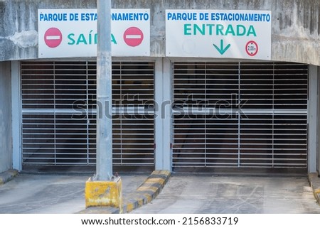 The entry and exit signs for vehicles to an underground car park