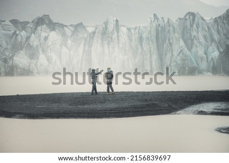 A tourists take pictures of the fascinating view of the ice glacier and lake