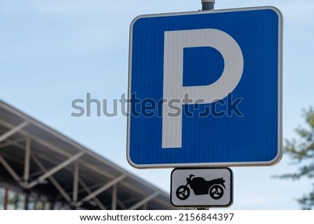 A motorcycle parking sign in the street