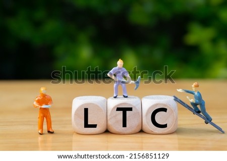 LTC.concept of virtual currency mining . Digital currency and virtual assets theme.Defi.written word on dice,miniature workers digging.