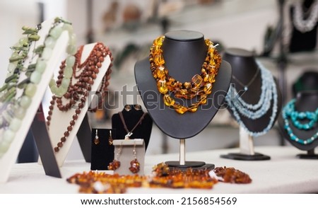 Counter with amber jewelry in store. High quality photo Royalty-Free Stock Photo #2156854569