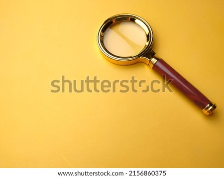 Vintage Brass Color Pocket Magnifying Glass,Magnifier Gift 60mm Portable on a yellow background.