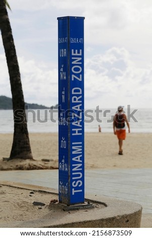 A tsunami warning sign is seen in Patong Beach, Phuket, southern Thailand. The sign is written in English and Thai language.
