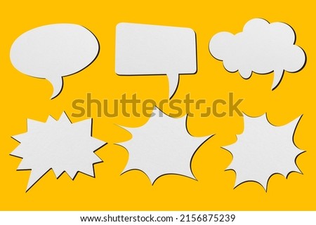 White paper in the shape of soap bubbles set against a yellow background. Royalty-Free Stock Photo #2156875239