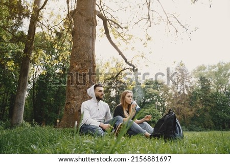 Cute couple have a rest in a summer forest