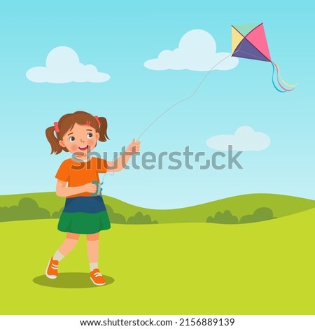 cute little girl enjoying playing kite in the park on summertime