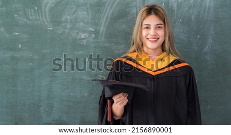Student holding graduation caps during commencement Graduation cap in the graduation ceremony.
