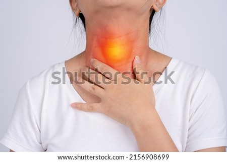 Woman with pain in the throat on a white background She has tonsils. Royalty-Free Stock Photo #2156908699
