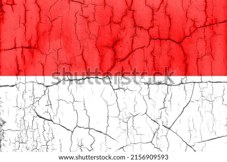 Textured photo of the flag of Indonesia with cracks.