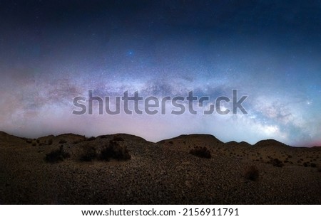 A long-exposure shot of a starry night over a deserted area