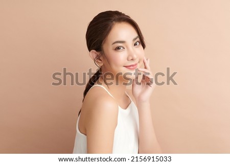 Beautiful young asian woman with clean fresh skin on beige background, Face care, Facial treatment, Cosmetology, beauty and spa, Asian women portrait. Royalty-Free Stock Photo #2156915033