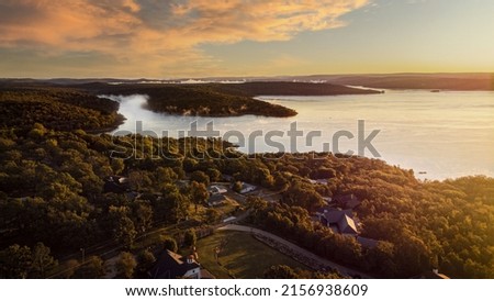 The sunset sky over the Tenkiller lake, Oklah and green forested area in the evening Royalty-Free Stock Photo #2156938609