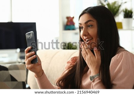 Cute brunette girl take selfie on smartphone, express surprise for picture, content for social media