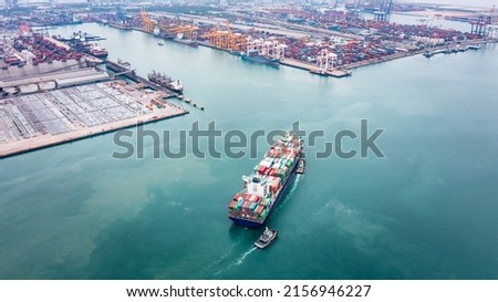 Container ship and tugboat draging to dock transporting cargo logistic import and export goods internationally around the world, including Asia Pacific and Europe, Aerial view photograph from drone 