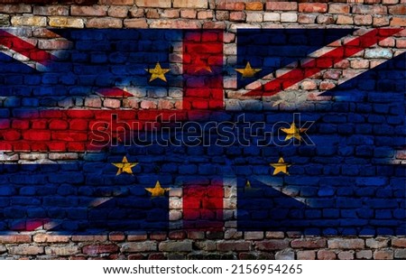 Brexit Concept. European Union EU flag on Old Broken Wall Covered by Great Britain flag Boris Johnson Liz Truss Trade policy  Royalty-Free Stock Photo #2156954265