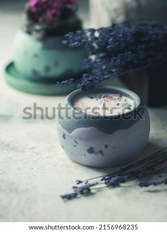 Soy candle in a concrete, plaster candlestick, decor interior. Home decoration with a burning scented candle. Spa. Natural. Copy space for text, selective soft focus