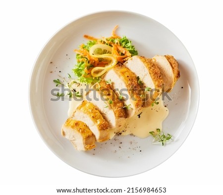 Top view of ceramic plate with appetizing slices of chicken breast with fresh vegetables and herbs served on white isolated background Royalty-Free Stock Photo #2156984653