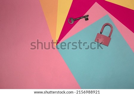 padlock and key on a colorful pastel background