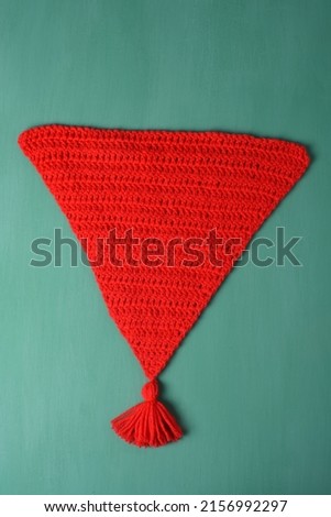 
red crochet pennant with pompom. Parti decoration