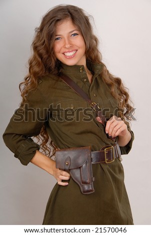 beautiful brunette girl in military clothes on grey background