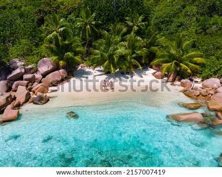 Anse Lazio Praslin Seychelles, a young couple of men and women on a tropical beach during a luxury vacation in Seychelles. Tropical beach Anse Lazio Praslin Seychelles Royalty-Free Stock Photo #2157007419