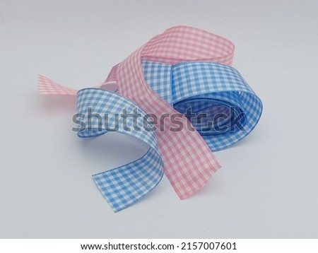 soft color ribbons with gingham pattern looked cute and girly. It can be  used to decorate a gift.