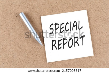 SPECIAL REPORT text on a sticky note on cork board with pencil ,