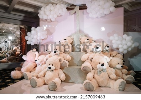 Pink photo zone with balloons and teddy bears, one year birthday party rich decorated 