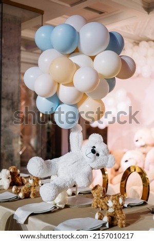 Pink and blue photo zone with balloons and teddy bears toys, one year birthday party rich decorated 