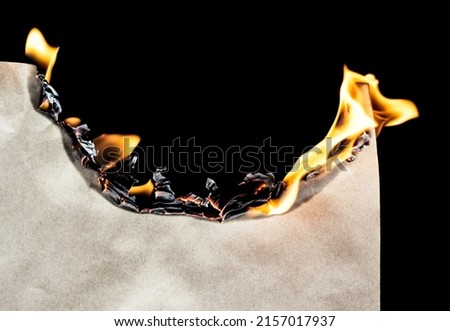 Burning paper isolated on black background Royalty-Free Stock Photo #2157017937