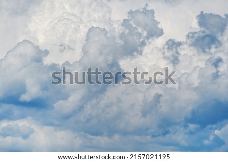Summer sky. Light cloudy, good weather. Heaven and infinity. Beautiful bright blue background. Curly clouds on a sunny day. White clouds in the blue sky.