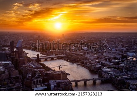 Beautiful, elevated sunset behind the skyline of London with bridges over the Thames river and St. Pauls Cathedral, England